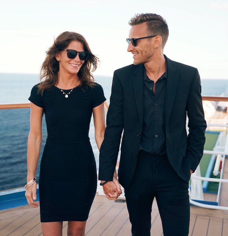 Photo by Allen Taylor a man and woman wearing sunglasses and standing on a deck